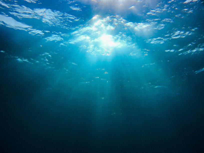 Light breaking through a deep ocean