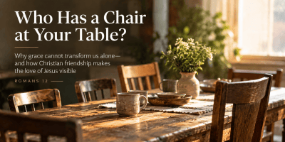 A warm wooden table surrounded by empty chairs, illustrating Christian community, friendship, grace, and the invitation to make room for others.